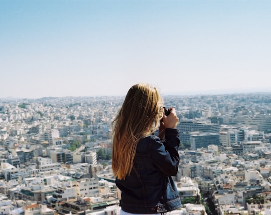 woman taking photo the city