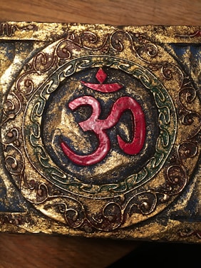 Warm orange heart symbol with tantric design on a soft lavender background.