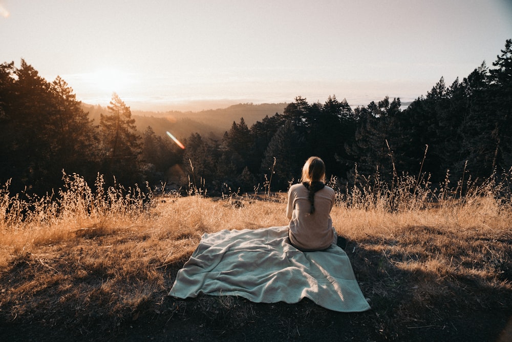 person sitting in front of trees