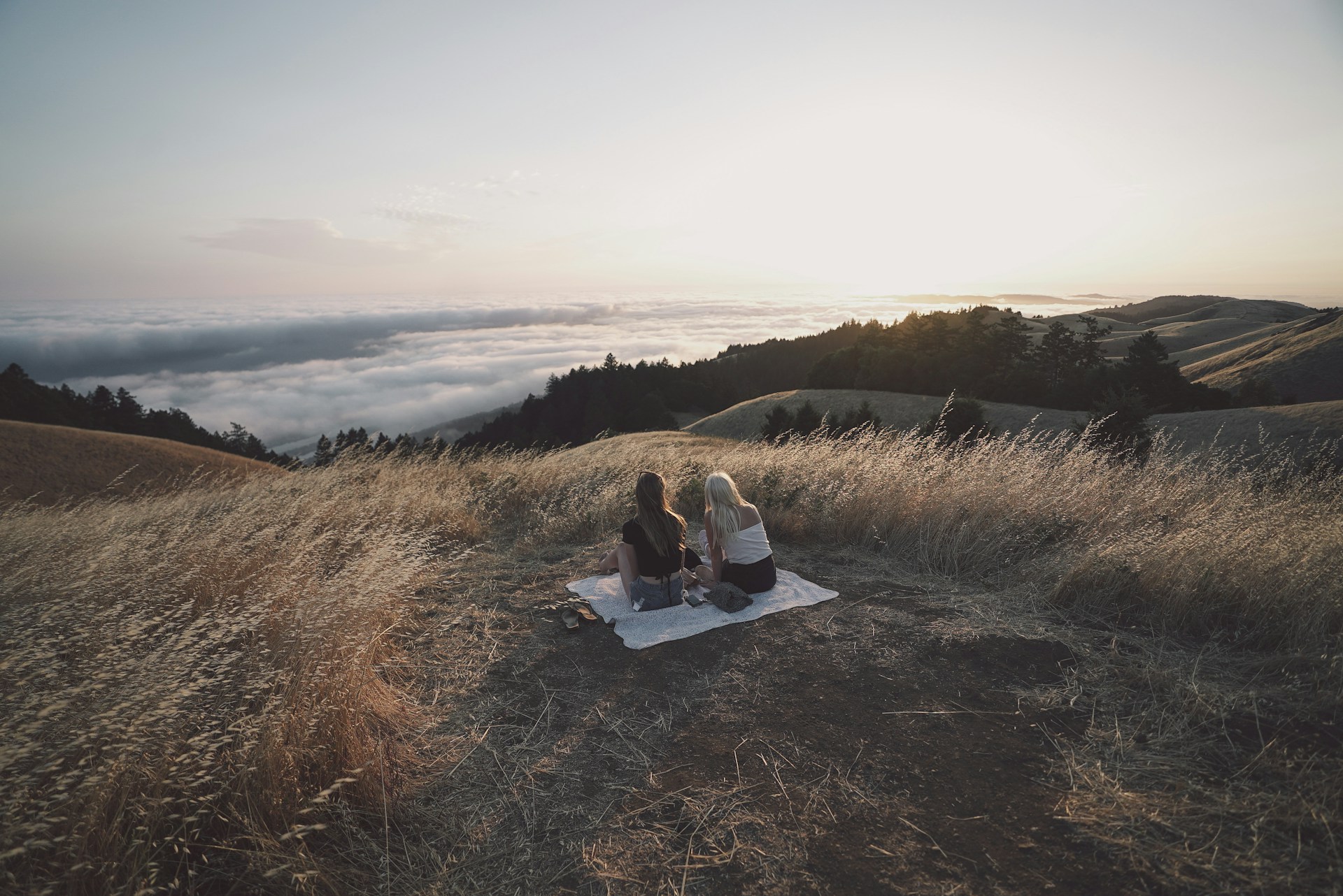 two woman picnic on hill