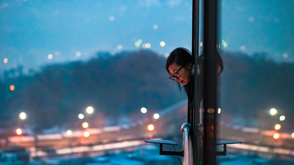 focus photography of woman wearing black framed eyeglasses