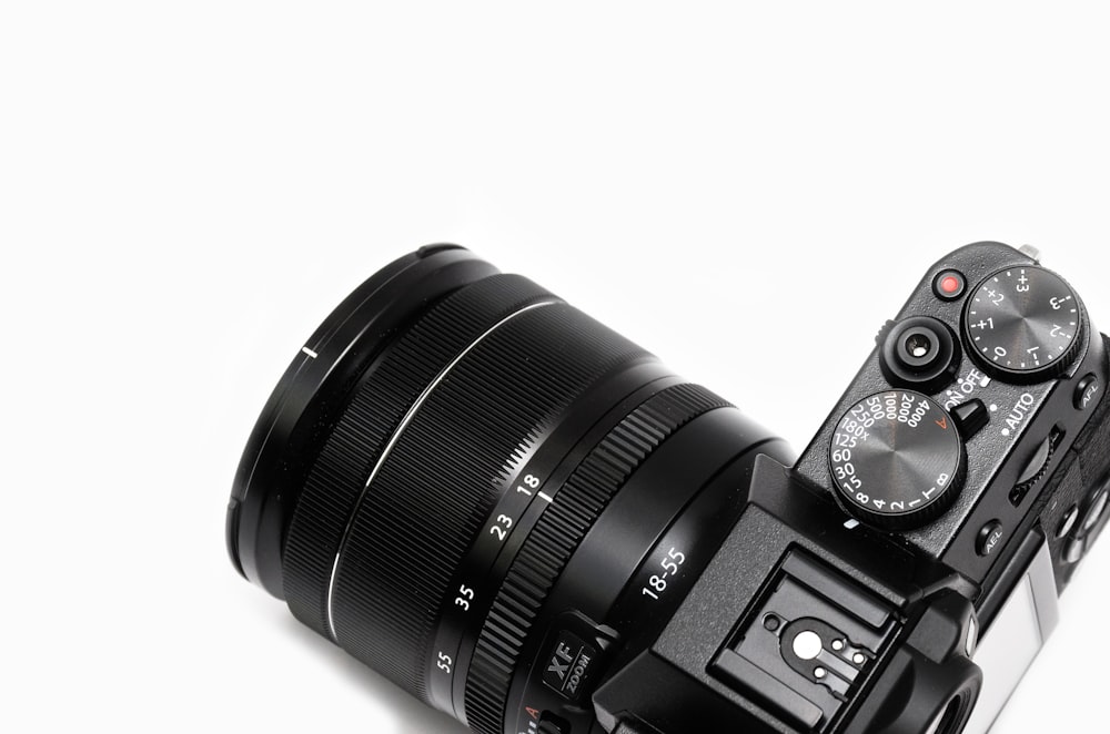 black DSLR camera with lens