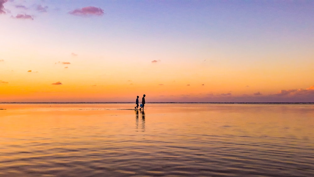 two person standing in sea