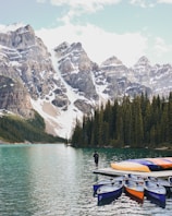 man standing on edge of boat on Banff National Park