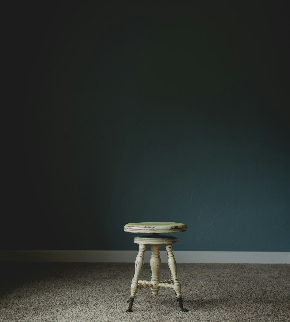 white wooden stool chair near wall