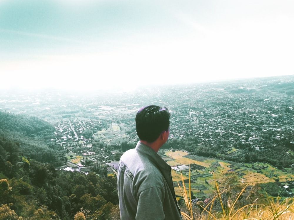 man facing buildings and houses