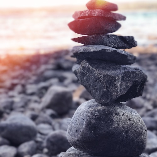 stack of stones near seashore at daytime