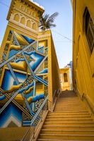 low-angle photo of beige concrete building and concrete stairs