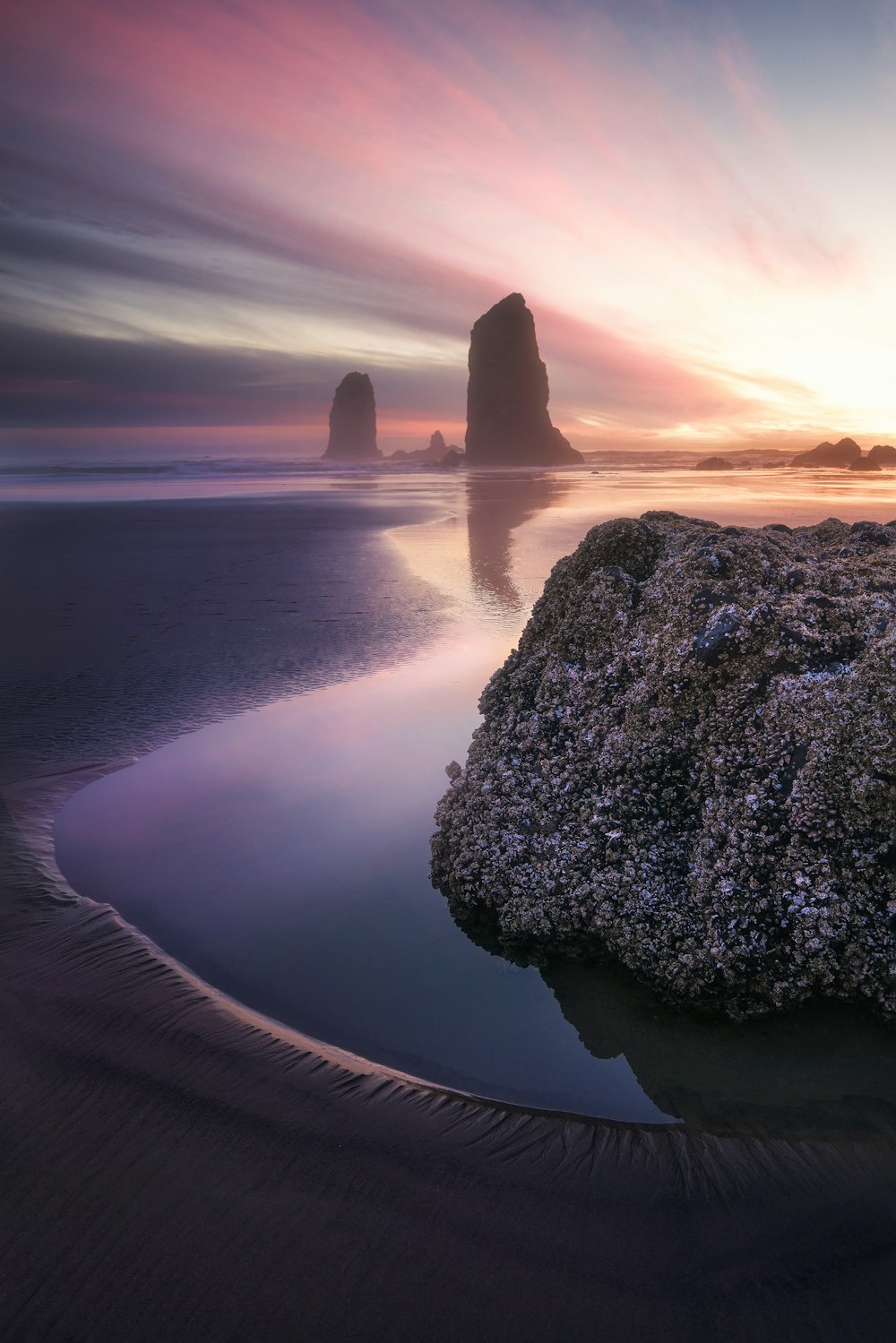 body of water near rock at daytime