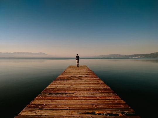 person on dock near body of water in Ohrid North Macedonia