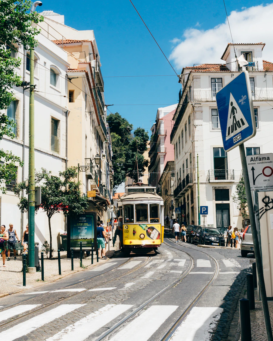 Yellow Tram 28 traveling through Alfama in Lisbon