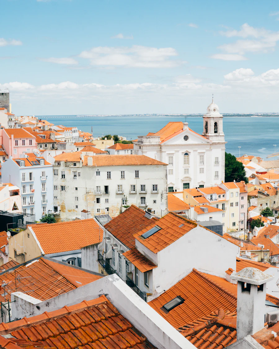 Terracotta rooftops of Lisbon's Alfama by the Tagus