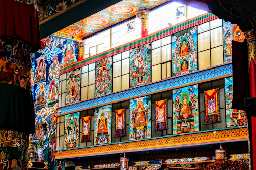 Volunteers painting temple walls in vibrant gold and white hues.