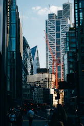 selective focus photo of crane near glass buildings
