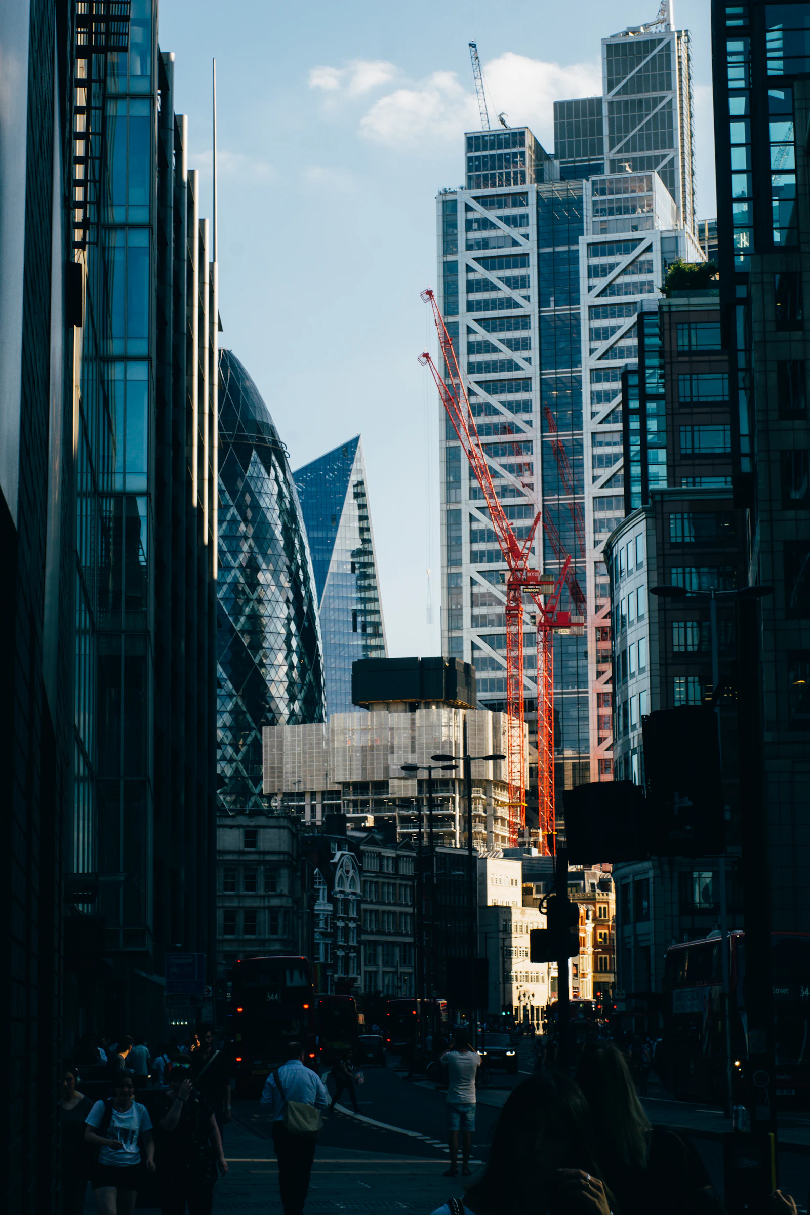 Tower crane beside modern glass buildings