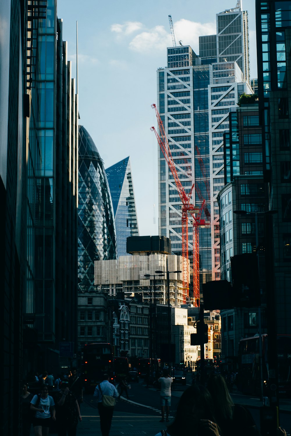 selective focus photo of crane near glass buildings