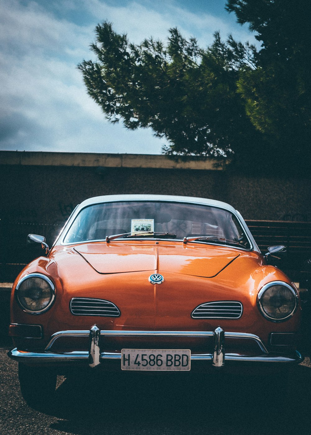 vintage orange car near tree