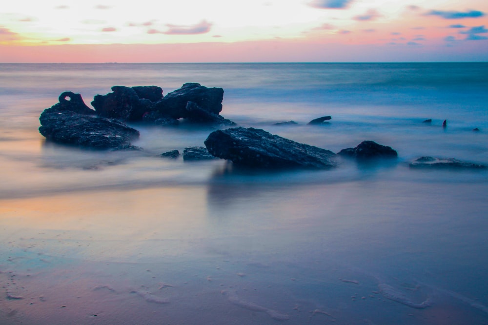 rock formation on beach during golden hour