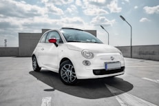 white 3-door hatchback on gray floor