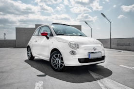white 3-door hatchback on gray floor