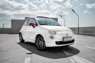 white 3-door hatchback on gray floor