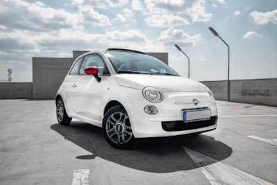 white 3-door hatchback on gray floor