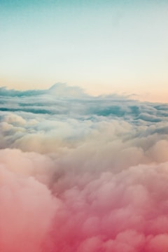A serene cloudscape blending into a creative workspace, symbolizing imagination turning real.