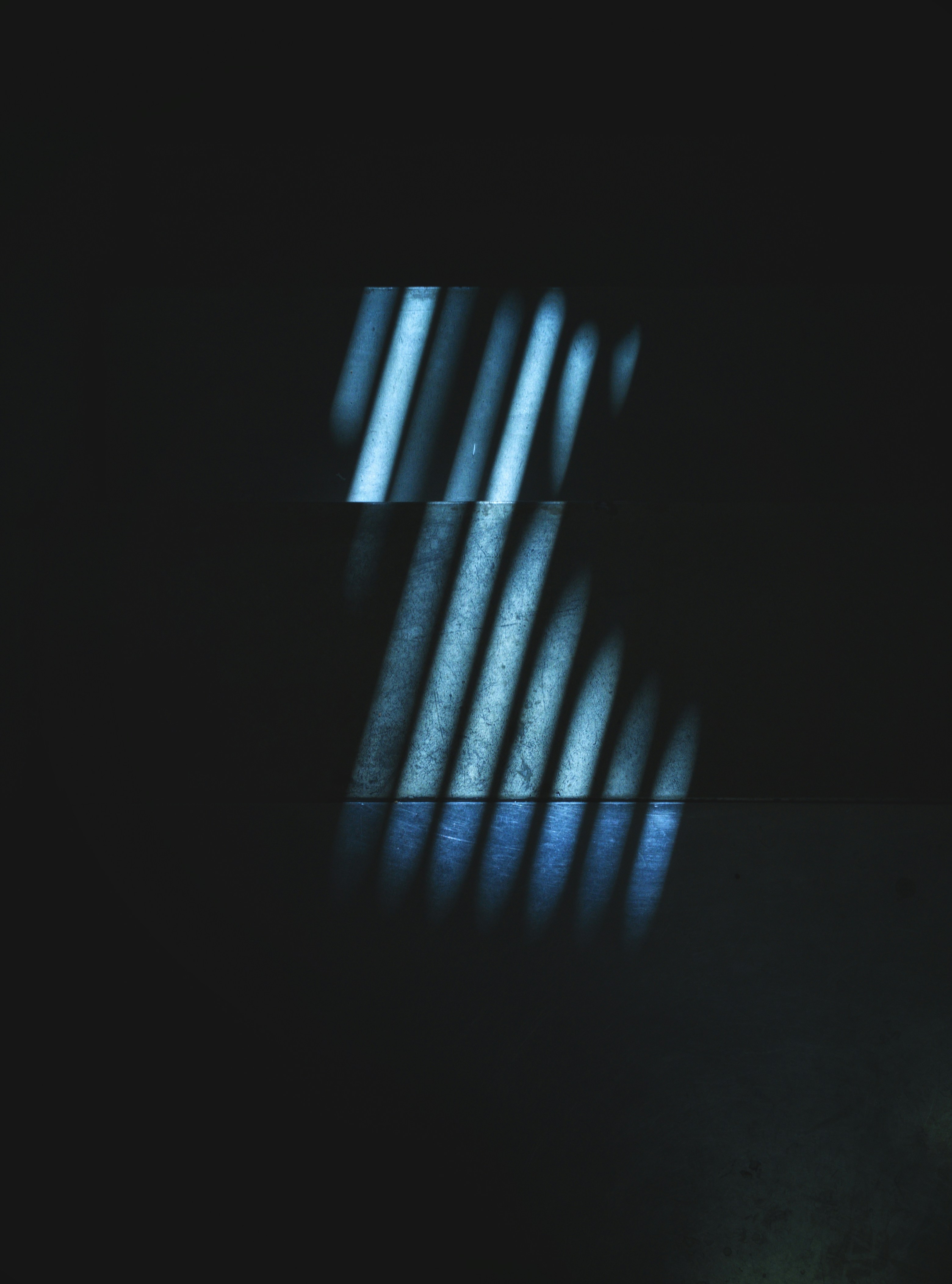 a dark room with light coming through a window