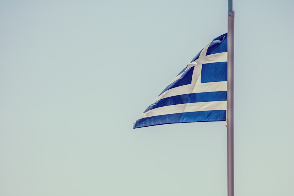 blue and white striped flag on pole