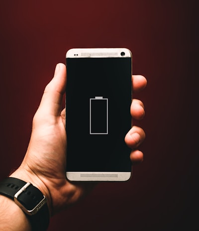 person holding low battery smartphone