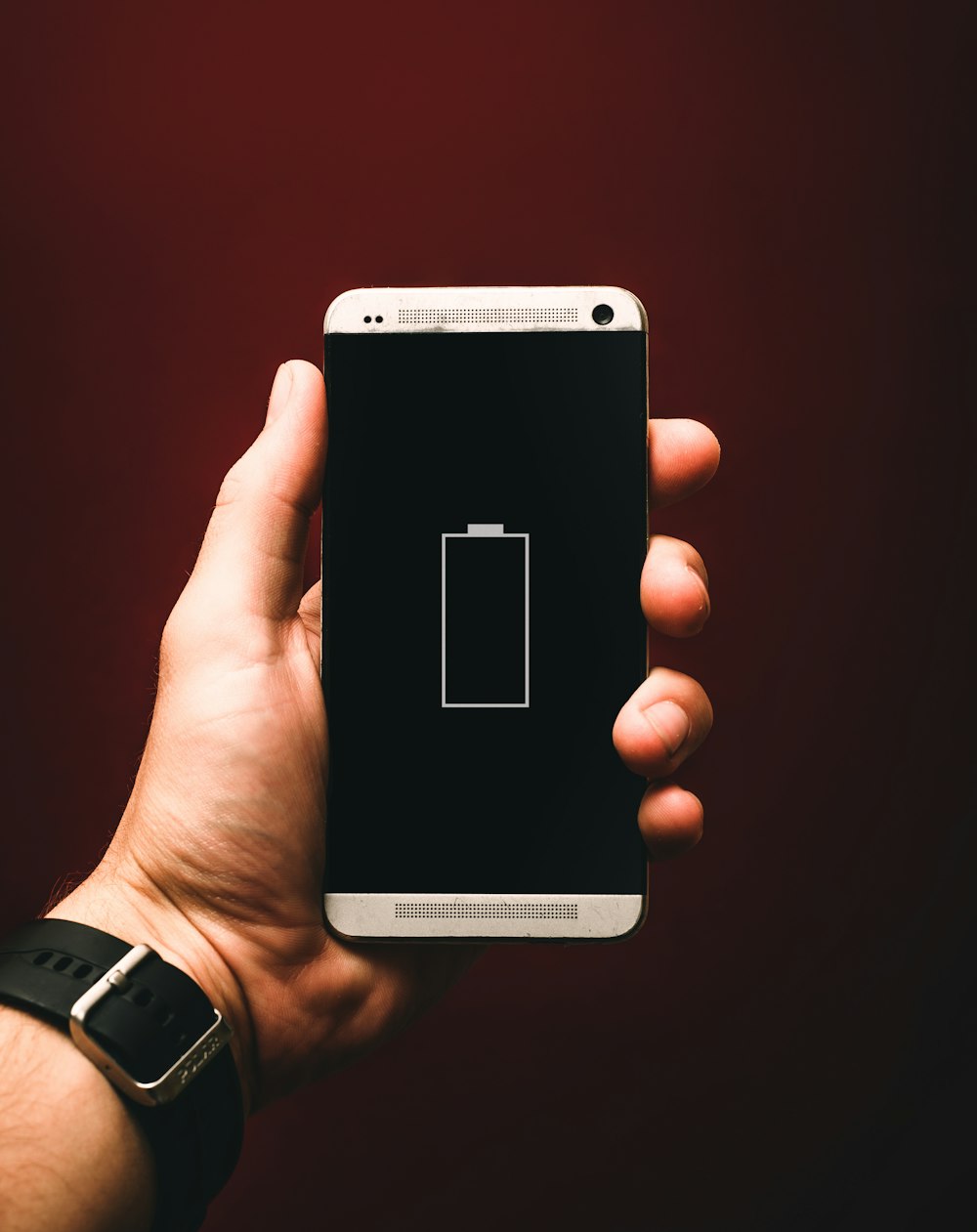 person holding low battery smartphone