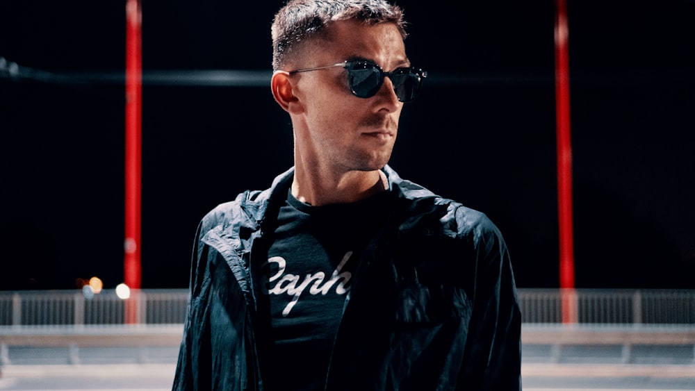 man wearing black jacket and sunglasses close-up photo