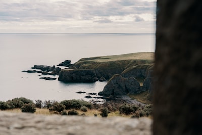 production company aberdeen scotland: aerial view photography of seacliff under nimbus clouds