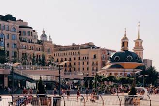 A vibrant church gathering in a sunlit urban plaza, with diverse people sharing fellowship.
