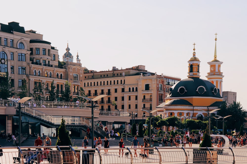 people in a plaza near buildings during daytime