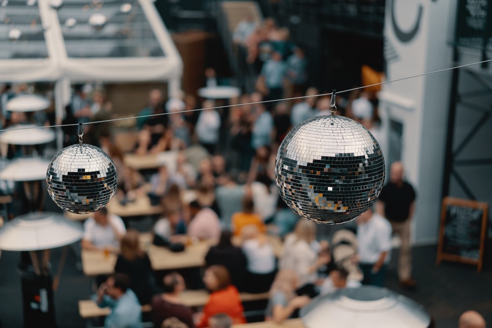 two hanging silver disco balls in shallow focus photography