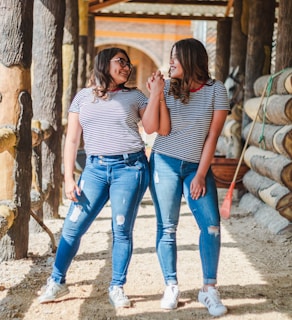 two smiling women while holding their hands at daytime