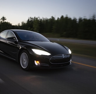 time-lapse photography of black sedan on road