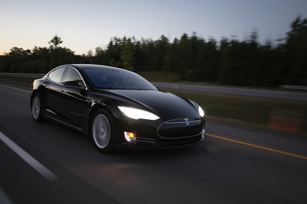 time-lapse photography of black sedan on road