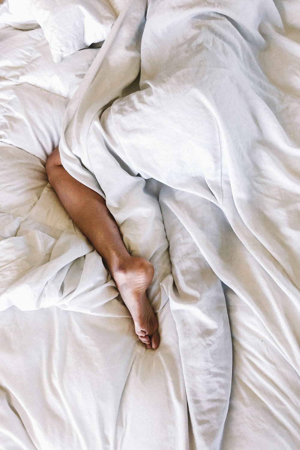 woman covered with white blanket