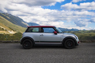 A compact car ready for a weekend getaway on a scenic road.