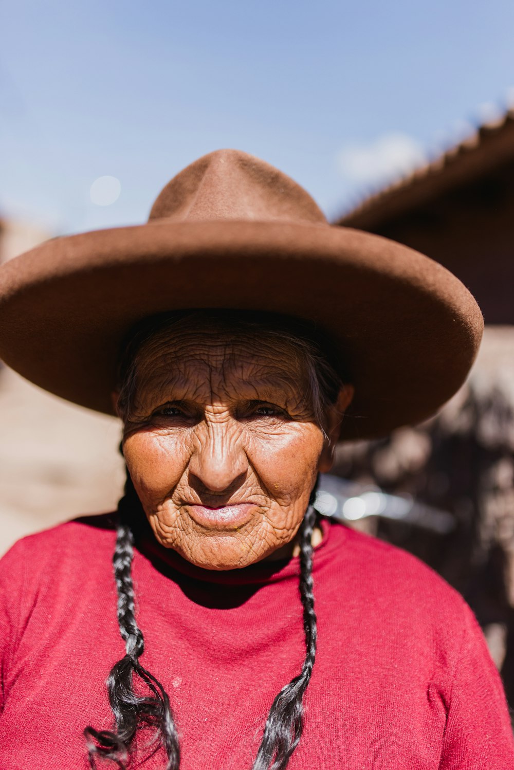 selective focus photo of woman wearing brown hat during daytime