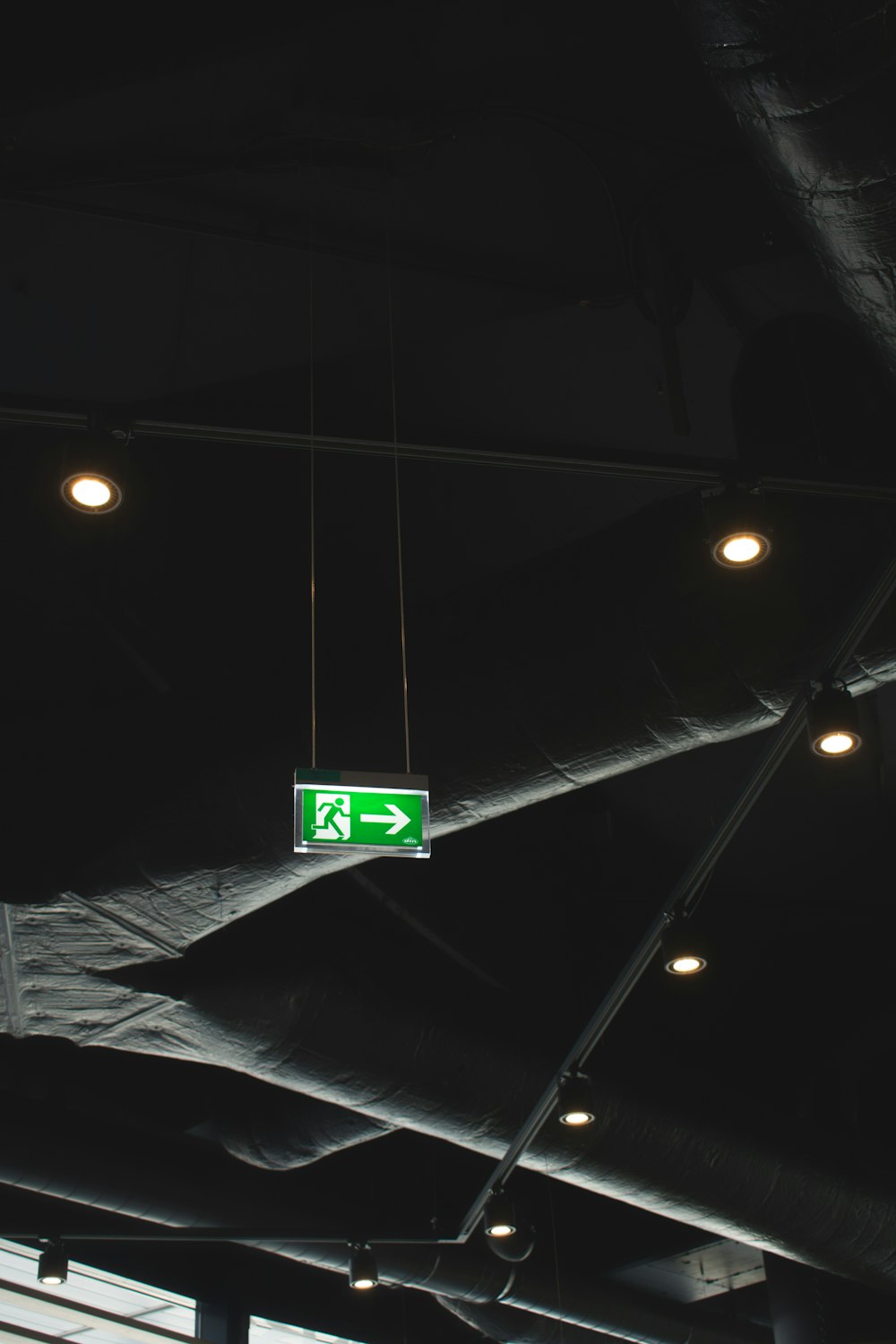 green signage on ceiling