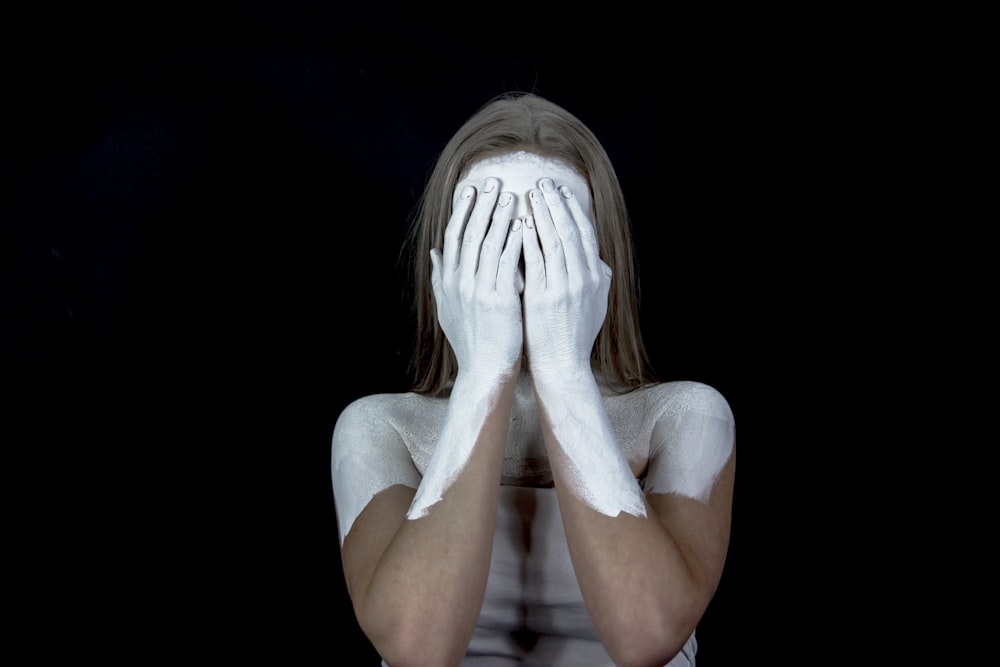 woman with white painted hand and face