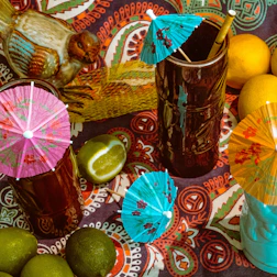 Joyful party scene with a topping bar and snacks, surrounded by tropical decorations.