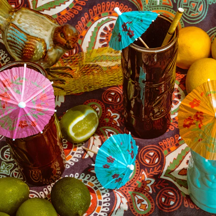 A vibrant tropical bar scene with colorful cocktails and lush greenery in the background.