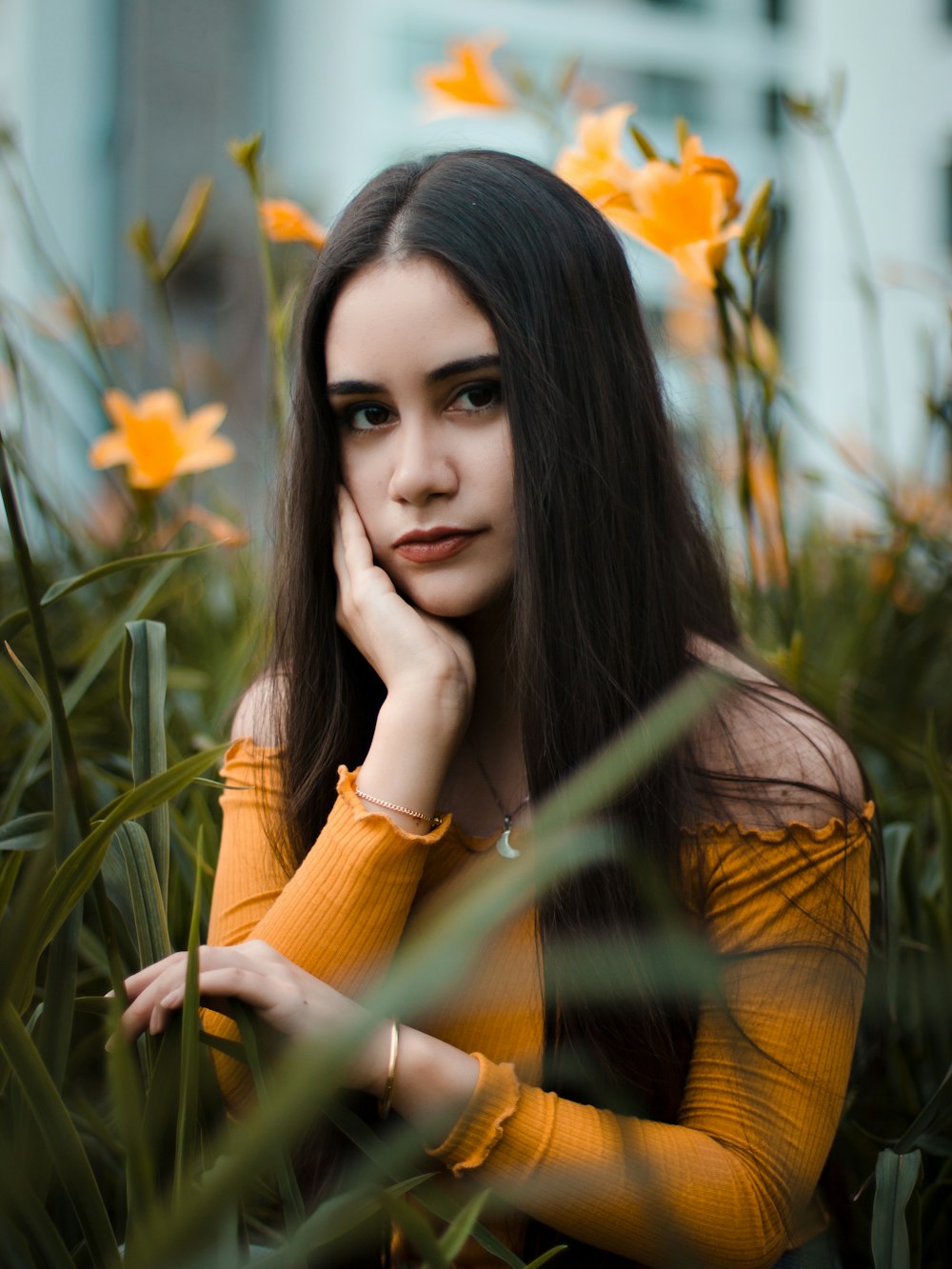 woman surrounded by grass during daytime