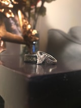 Close-up of wedding rings on a decorative surface.