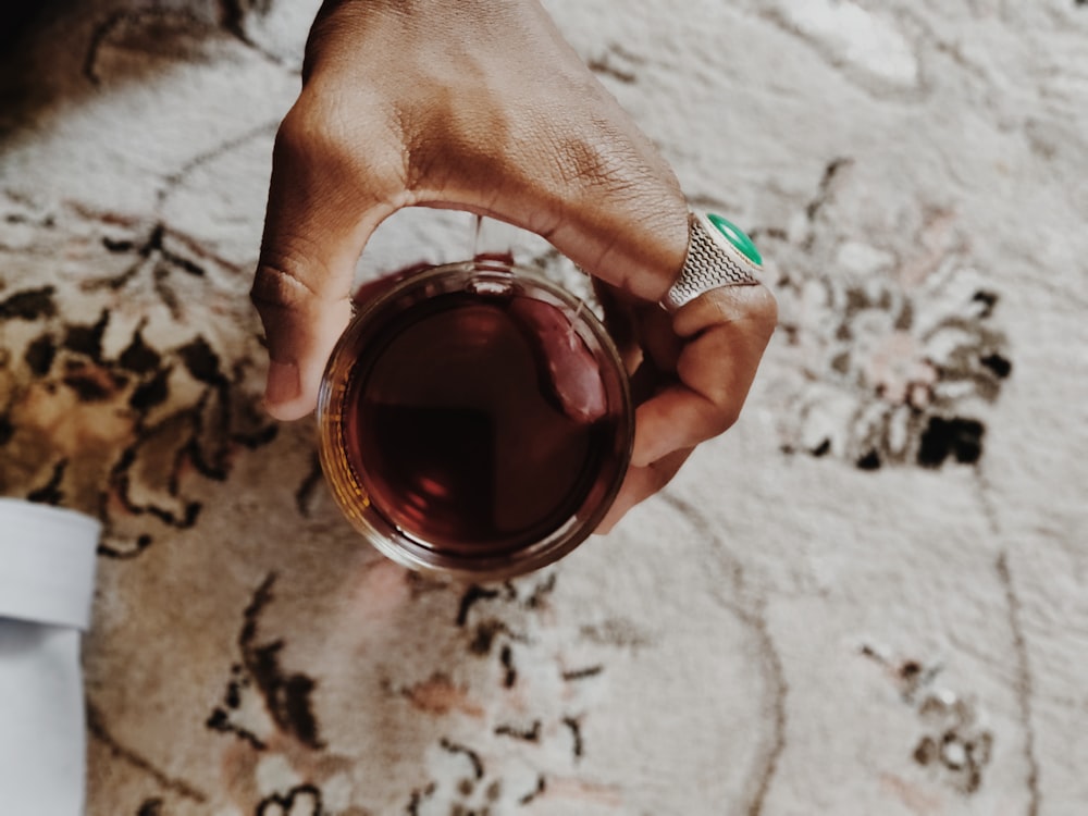 person holding highball glass