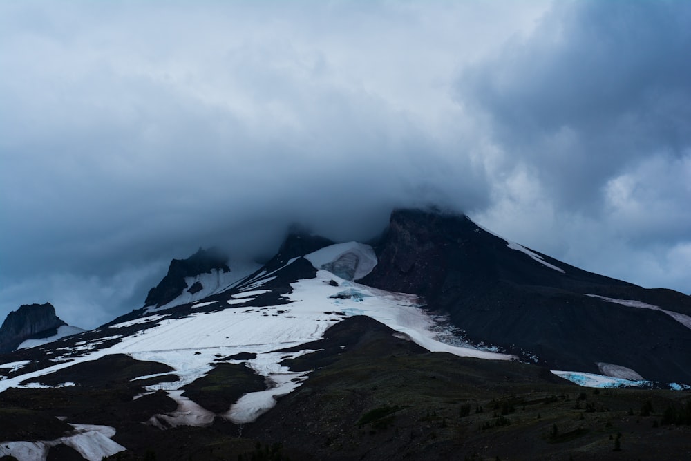 mountain with snow and clouds